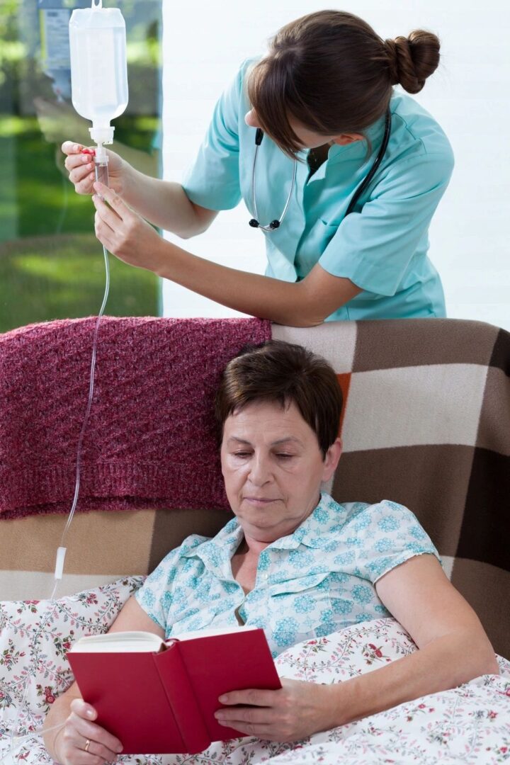 A nurse is using an electronic device to check the heartbeat of a patient.